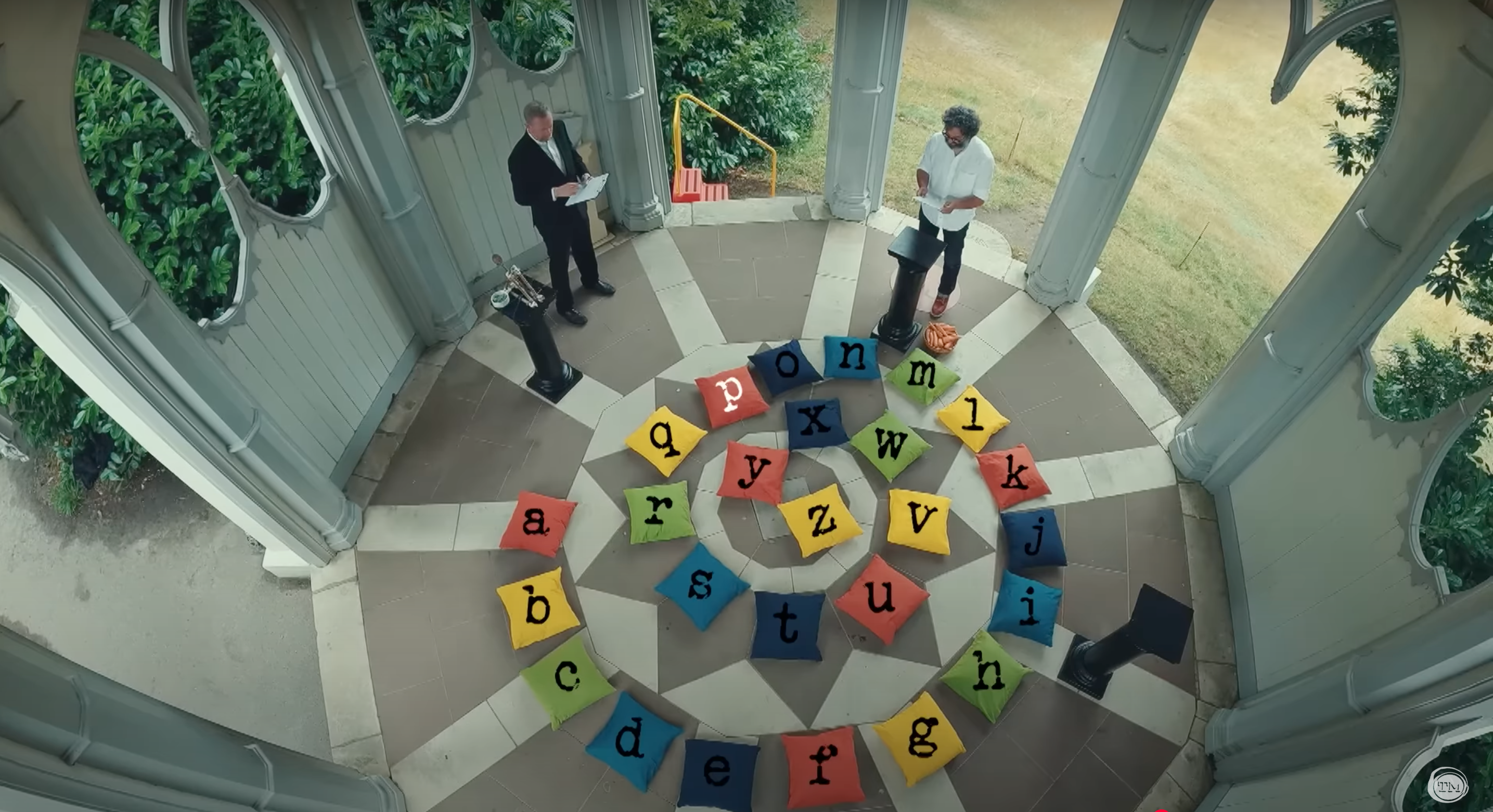 A spiral of 26 colored pillows, each labeled with a letter of the alphabet.