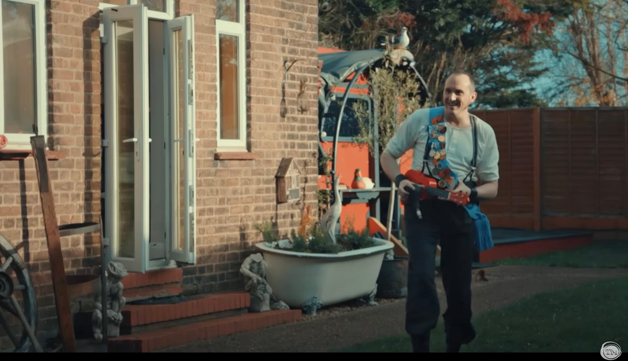 Phil Ellis plays a ukulele and honks a horn.